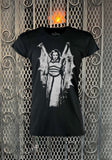 A black short-sleeve graphic T-shirt featuring a distressed white print of Lily Munster wearing a winged cape.