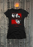 The Lost Boys black t-shirt featuring the movie imagery and the text "Sleep all day Party all night Never grow old Never die The Lost Boys" in red lettering, photographed flat on a metal gate background.