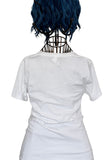 White short-sleeve crewneck t-shirt shown from the back on a black wire mannequin torso with blue hair, isolated on a white background.