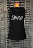Misfits logo black sleeveless t-shirt featuring the classic logo in white outlined lettering, photographed flat on a metal gate background.