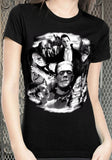 Black Universal Monsters Collage t-shirt featuring a glow in the dark print of Frankenstein, Bride of Frankenstein, Dracula, the Mummy, the Wolfman, and the Creature from the Black Lagoon, on a model against a metal gate background.