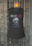Motley Crue black sleeveless t-shirt featuring the band logo with "Motley" in white and "Crue" in red lettering along with an illustration of a skull with handcuffs, photographed flat on a metal gate background.