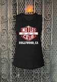 Motley Crue Hollywood black sleeveless t-shirt featuring a motorcycle  symbol with the band logo and the words "Girls, Girls, Girls" in white and red along with "Hollywood, CA" in large white letters, photographed flat on a metal gate background.