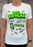 A white short-sleeve graphic t-shirt featuring a bold green and black design with the text 'BUNGLE THERE'S A TRACTOR in my BALLS' and hand-drawn doodles, worn by a model.