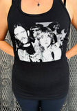 Black Ozzy Osbourne and Lemmy Kilmister tank top featuring a black and white image of them sticking up their middle fingers, on a model against a metal gate background.