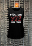 Police Ghost in the Machine 1982 Tour sleeveless black t-shirt featuring album artwork, photographed flat on a metal gate background.