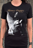 Skinny Puppy Greyhound London black t-shirt featuring the venue artwork for the show on May 25th, 1988, photographed on a model in front of a metal gate background.