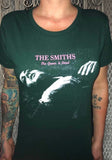 The Smiths The Queen is Dead green t-shirt featuring the album artwork, photographed on a model in front of a metal gate background.