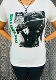 The Smith's Meat is Murder white t-shirt featuring artwork from the album, photographed on a model in front of a metal gate background.