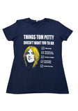 Tom Petty navy t-shirt featuring a drawing of his head and a checklist of "Things Tom Petty Doesn't Want You to Do" such as "Fade on Him" and "Live Like a Refugee", displayed on a white background.