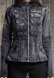 A woman wearing a dark gray, heavily distressed jacket with multiple rows of silver grommets and zippers.