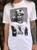 Debbie Harry of Blondie white t-shirt featuring a black and white image of her wearing a Popeye t-shirt while she is wearing a captain's hat and saluting, on a model.