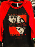 Close-up of The Lost Boys black raglan t-shirt with red 3/4 sleeves featuring the movie imagery along with red text that reads "Sleep all day Party all night Never grow old Never die The Lost Boys".