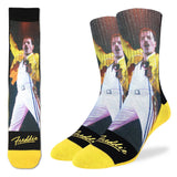 Crew socks featuring an image of Freddie Mercury singing at Wembley wearing a yellow jacket with yellow toe area and the word "Freddie" in yellow script across the feet, photographed on a white background.