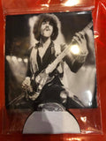 Thin Lizzy Coozie featuring a black and white image of Phil Lynott playing guitar, photographed in the clear cellophane packaging.
