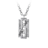A silver-toned metal Judas Priest razor blade pendant necklace with engraved "British Steel" text and logo, suspended from a matching chain, photographed on a white background.