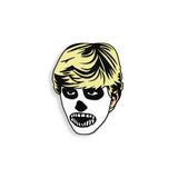 Close-up of Karate Kid enamel pin featuring Johnny in skull makeup with yellow hair, photographed on a white background.