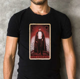 Close-up of black Dracula t-shirt featuring Dracula as the Emperor tarot card, on a textured background.